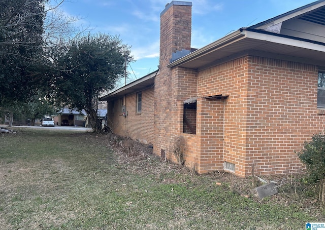 view of side of home featuring a lawn