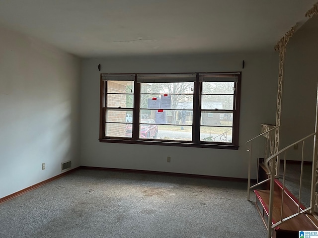 empty room featuring a healthy amount of sunlight and carpet floors