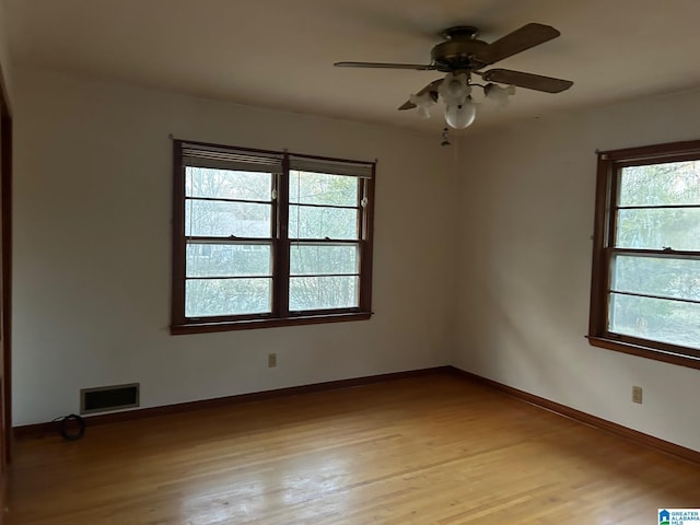 unfurnished room featuring ceiling fan, light hardwood / wood-style floors, and a healthy amount of sunlight