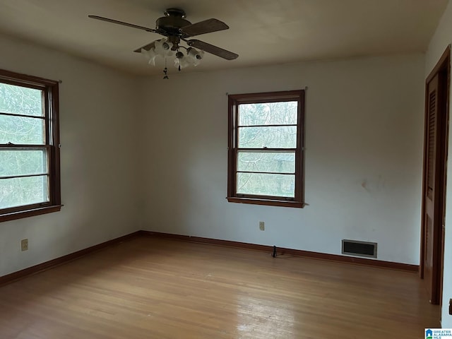 spare room with ceiling fan and light hardwood / wood-style floors