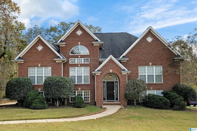 view of property featuring a front lawn