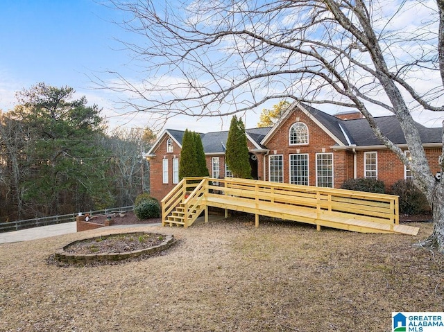 rear view of property featuring a wooden deck