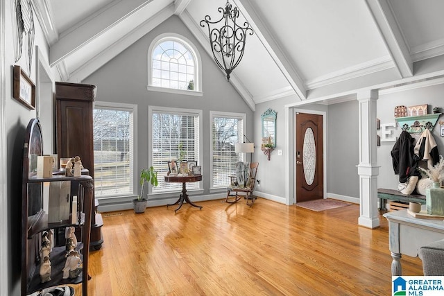 foyer featuring ornate columns and wood-type flooring