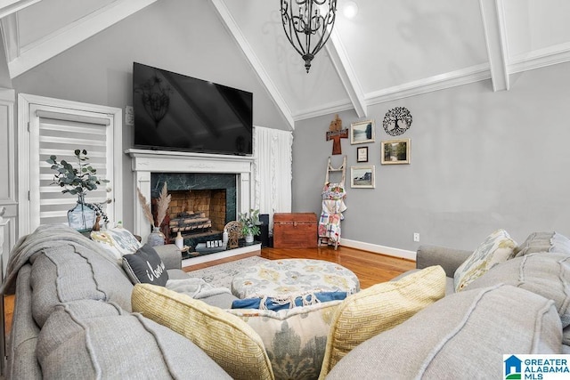 living room with vaulted ceiling with beams, a high end fireplace, and hardwood / wood-style flooring