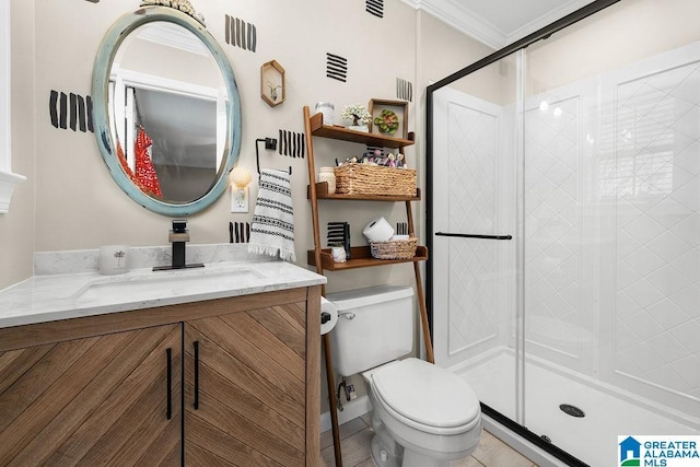 bathroom featuring walk in shower, tile patterned flooring, crown molding, toilet, and vanity