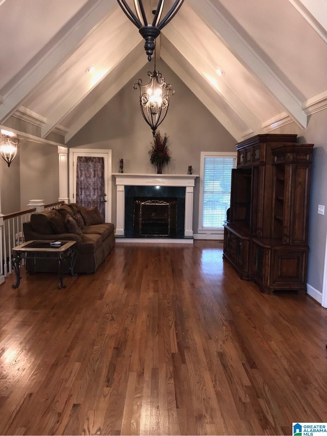 unfurnished living room with dark hardwood / wood-style floors, lofted ceiling with beams, a premium fireplace, and an inviting chandelier