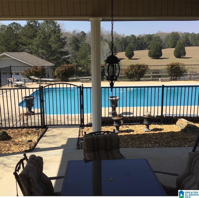 view of pool featuring a diving board and a patio area