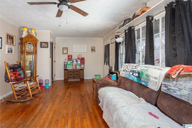 living room with hardwood / wood-style flooring, ceiling fan, crown molding, and a textured ceiling