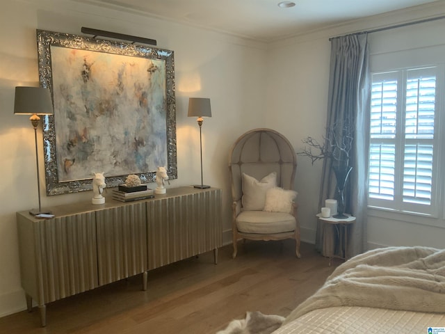 bedroom with wood-type flooring, radiator heating unit, and ornamental molding