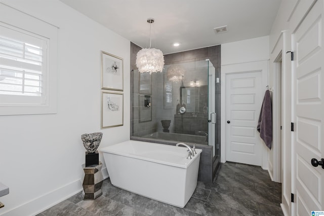 bathroom featuring a notable chandelier and shower with separate bathtub