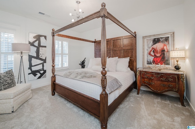 carpeted bedroom with an inviting chandelier