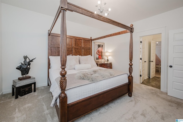 carpeted bedroom featuring a chandelier and connected bathroom