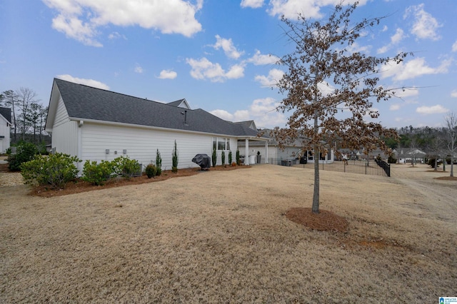 rear view of house featuring a lawn