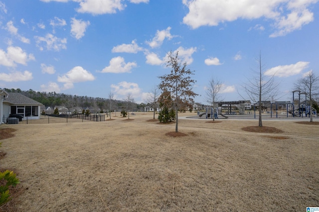 view of yard featuring cooling unit and a playground