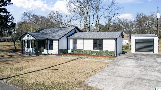 single story home with covered porch, a garage, and an outdoor structure