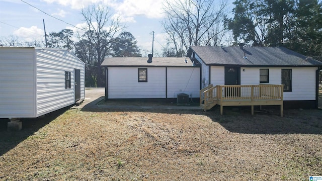 rear view of property featuring central air condition unit and a wooden deck