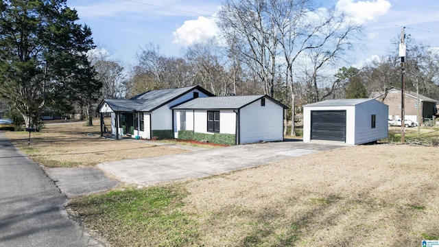 view of front of property with a garage and an outdoor structure