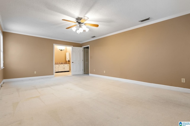 unfurnished bedroom featuring a textured ceiling, ceiling fan, ornamental molding, ensuite bath, and light colored carpet