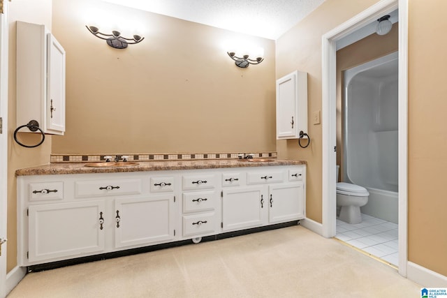 bathroom with toilet, a textured ceiling, tile patterned floors, and vanity