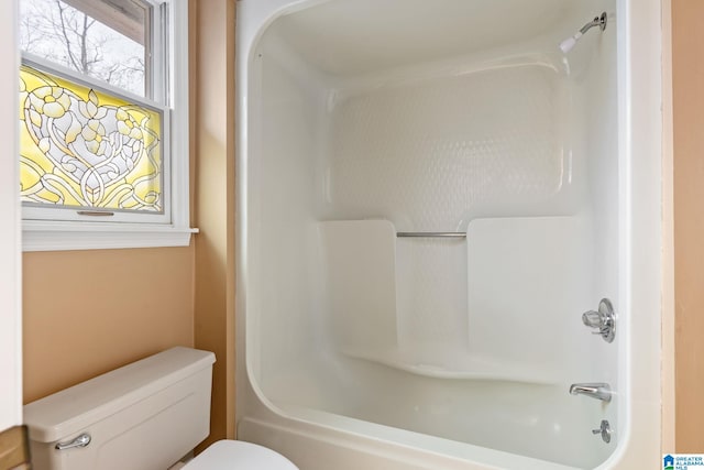 bathroom featuring toilet and  shower combination