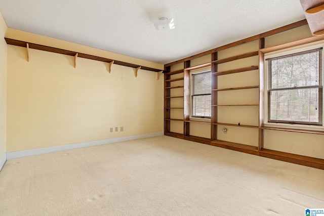 empty room with a textured ceiling and carpet