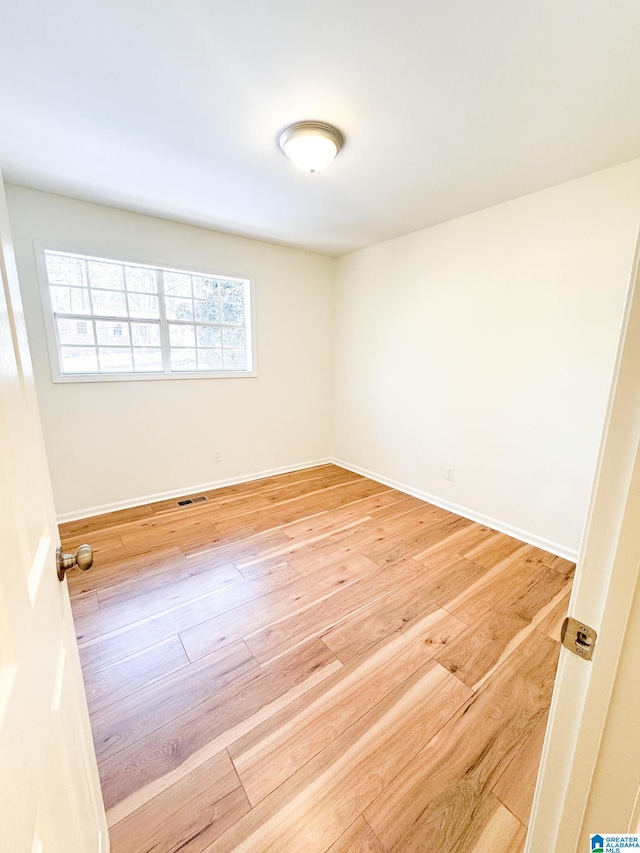 empty room with hardwood / wood-style flooring