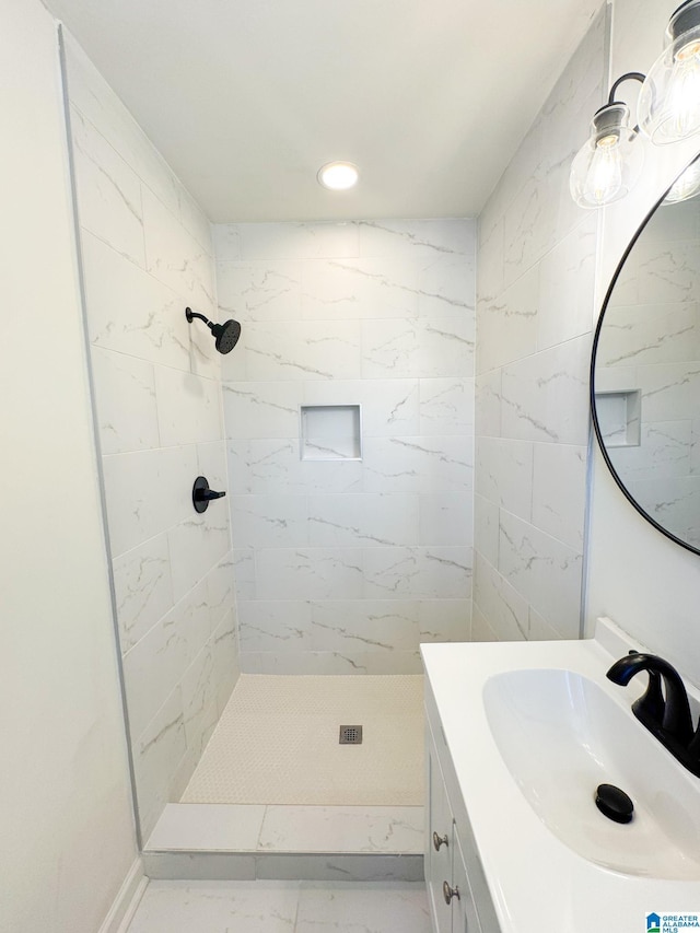 bathroom featuring vanity and tiled shower