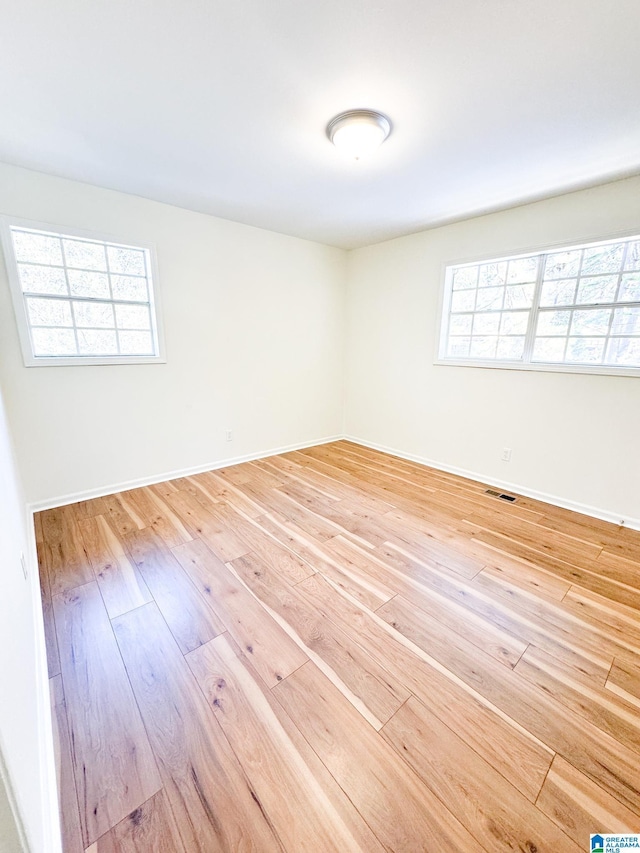 unfurnished room with wood-type flooring