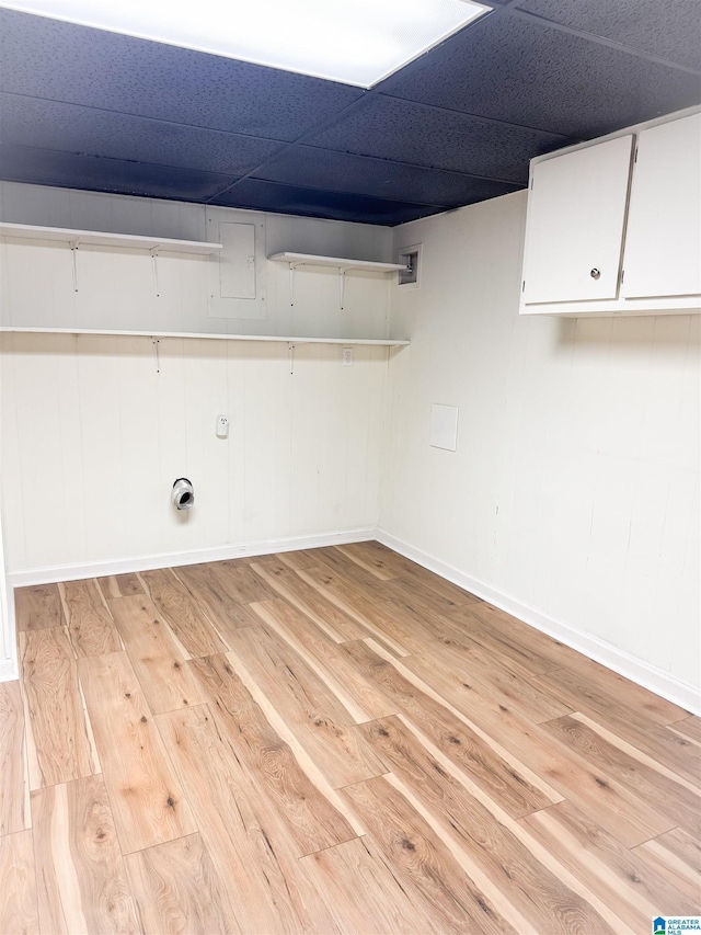 laundry area with cabinets and light hardwood / wood-style flooring