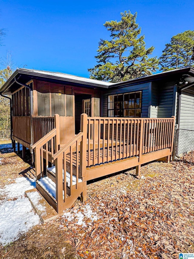 back of house featuring a wooden deck