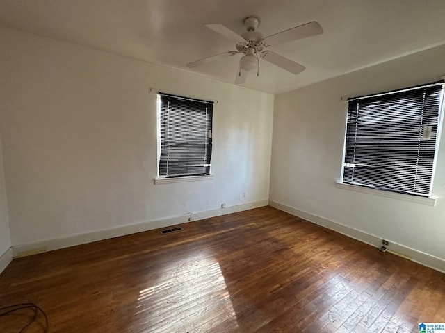 spare room featuring ceiling fan and dark hardwood / wood-style flooring