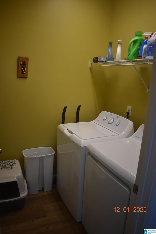 clothes washing area with independent washer and dryer and dark hardwood / wood-style flooring