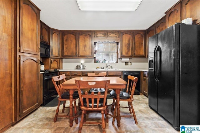 kitchen featuring sink and black appliances