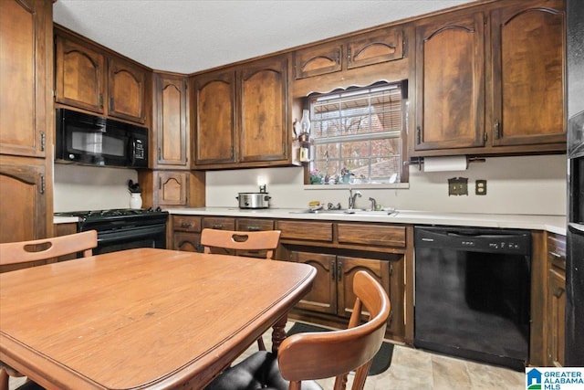 kitchen featuring sink and black appliances