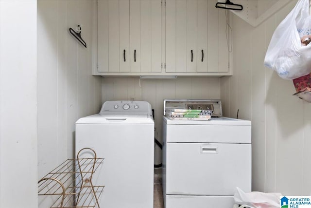 laundry room featuring washer and dryer and cabinets