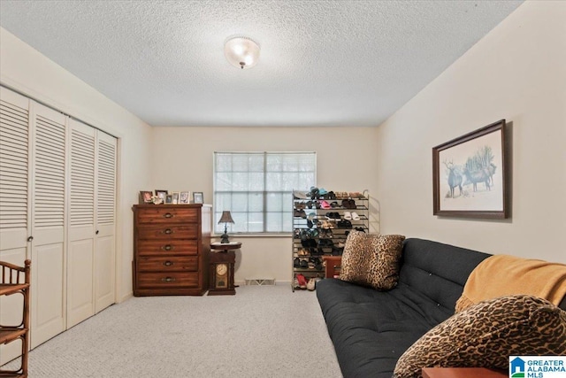 interior space featuring light carpet and a textured ceiling