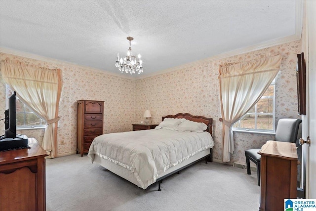 carpeted bedroom featuring a textured ceiling, crown molding, and a chandelier