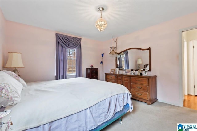 carpeted bedroom with a chandelier