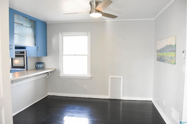 unfurnished dining area with ceiling fan, dark hardwood / wood-style flooring, and crown molding