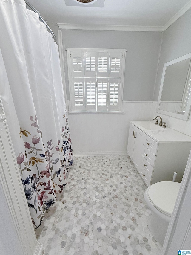 bathroom with vanity, toilet, and crown molding