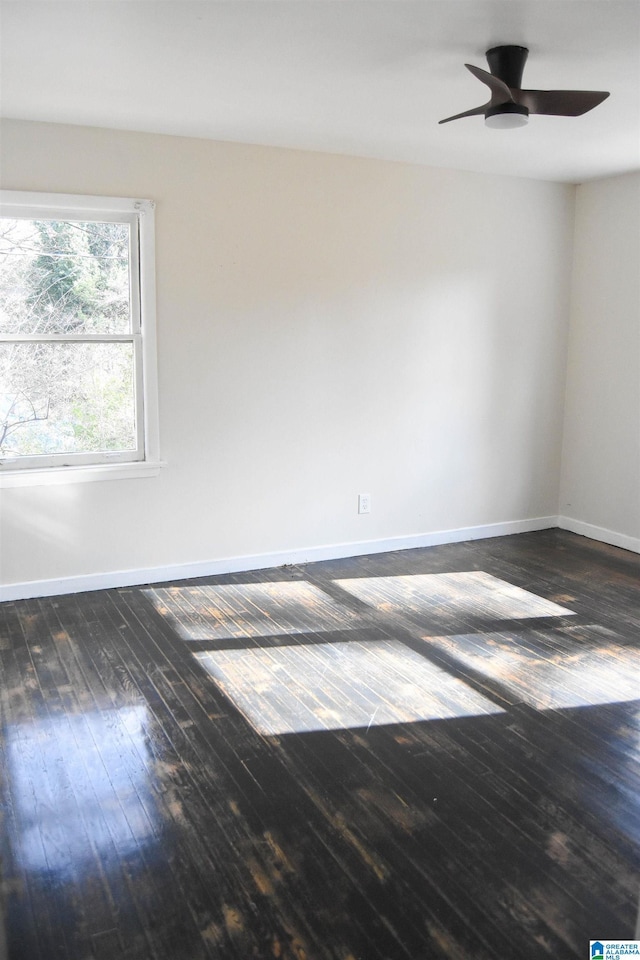 spare room with ceiling fan and dark hardwood / wood-style floors