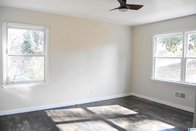 spare room featuring dark hardwood / wood-style floors, plenty of natural light, and ceiling fan