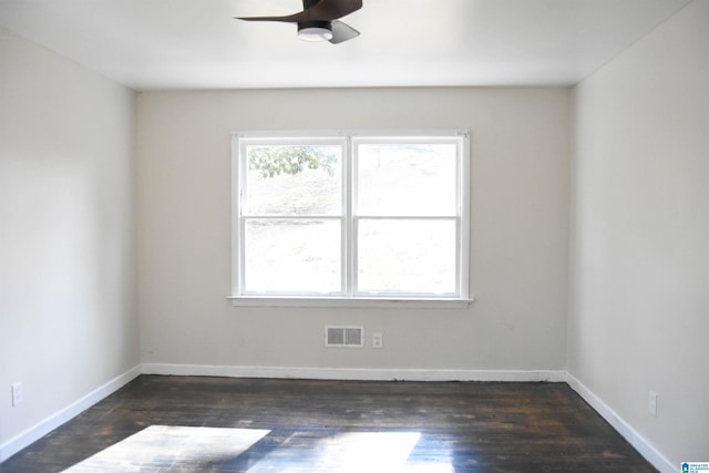 unfurnished room with ceiling fan and dark wood-type flooring