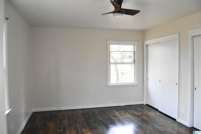 unfurnished bedroom featuring ceiling fan and dark wood-type flooring