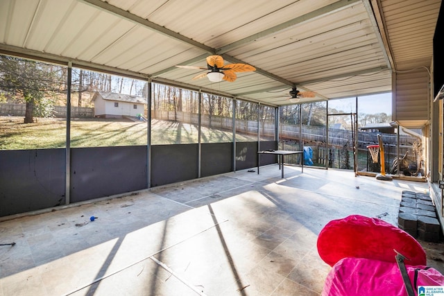 unfurnished sunroom with ceiling fan