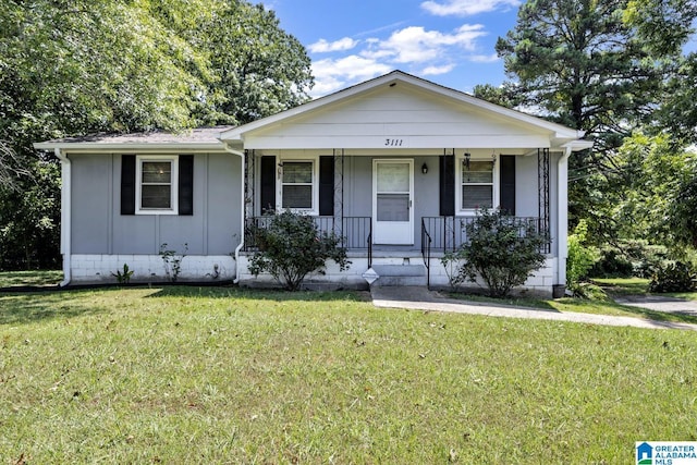 view of front of property with covered porch and a front yard