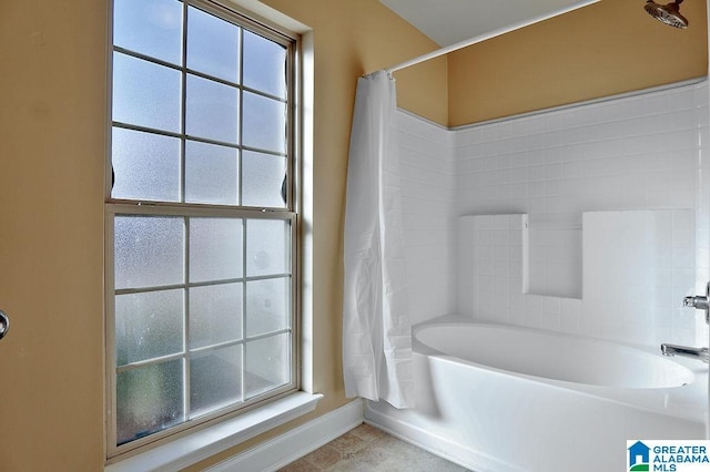 bathroom featuring tile patterned flooring and shower / bath combo with shower curtain