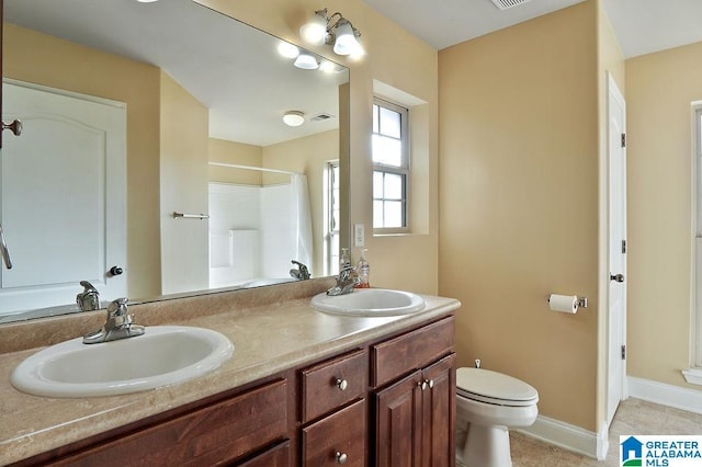 bathroom with tile patterned flooring, vanity, toilet, and a shower