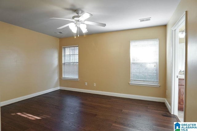 spare room with ceiling fan and dark wood-type flooring