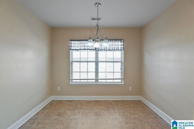 unfurnished dining area featuring a notable chandelier